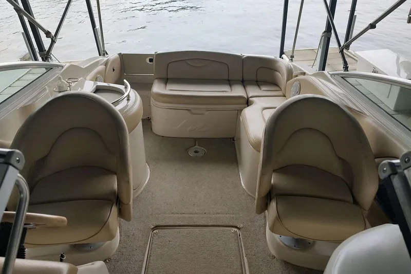 Slide: The Image of Interior of 2002 Sea Ray 270 Sundeck boat with beige seating and carpet. - 18