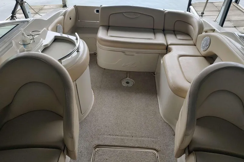 Slide: The Image of Interior of 2002 Sea Ray 270 Sundeck boat with beige seating and carpet. - 21