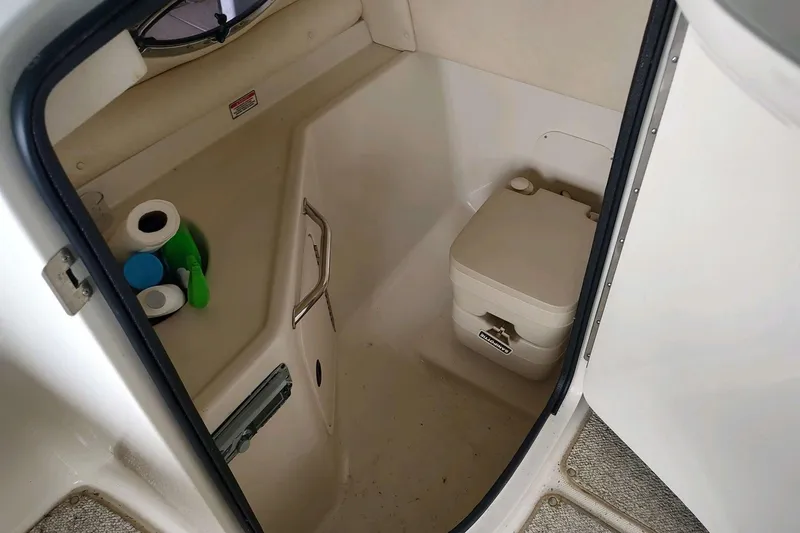 Slide: The Image of Interior of 2002 Sea Ray 270 Sundeck boat with compact toilet and storage. - 22