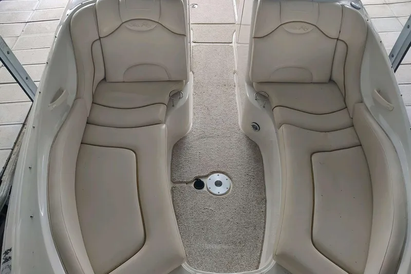 Slide: The Image of 2002 Sea Ray 270 Sundeck interior with beige seating and carpeted floor. - 24