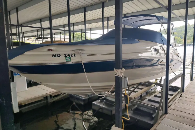 Slide: The Image of 2002 Sea Ray 270 Sundeck boat docked under a covered marina. - 26