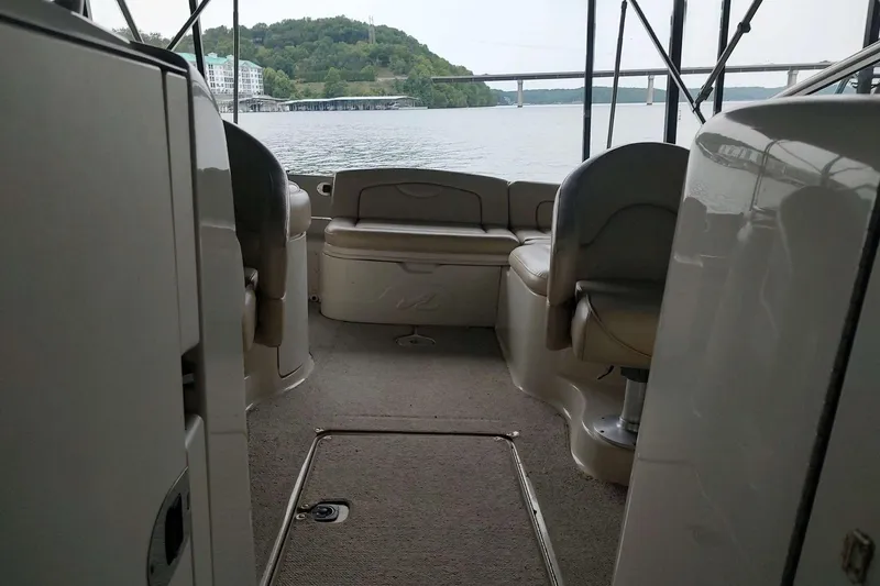 Slide: The Image of Interior view of 2002 Sea Ray 270 Sundeck boat with seating and lake backdrop. - 7
