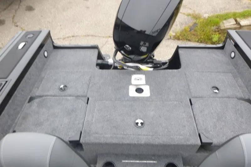 Slide: The Image of 2026 Tracker Targa V-19 Combo boat interior with gray carpeted deck and motor. - 11