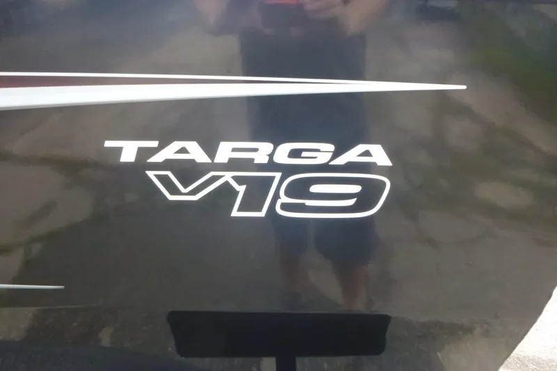 Slide: The Image of 2026 Tracker Targa V-19 Combo boat storage compartment with gear inside. - 15