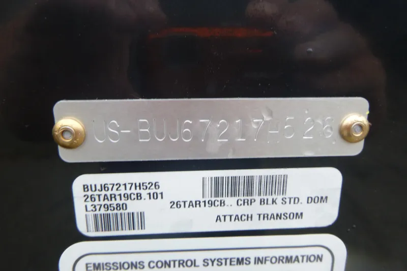 Slide: The Image of 2026 Tracker Targa V-19 Combo boat interior with open storage compartment and carpeted flooring. - 16