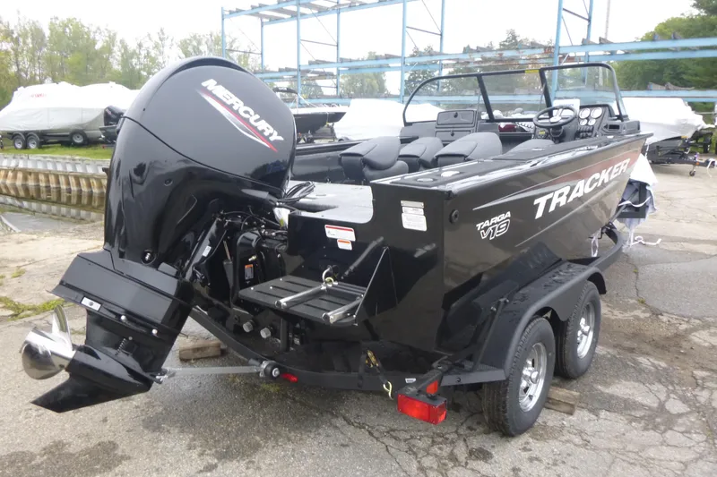 Slide: The Image of 2026 Tracker Targa V-19 Combo boat on trailer, side view, beige color. - 2