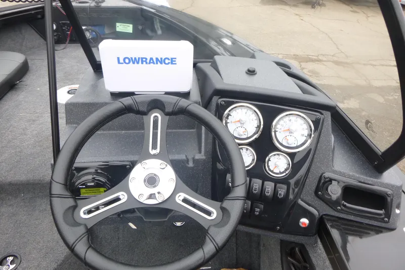 Slide: The Image of 2026 Tracker Targa V-19 Combo boat interior with green navigation light and water bottle. - 8