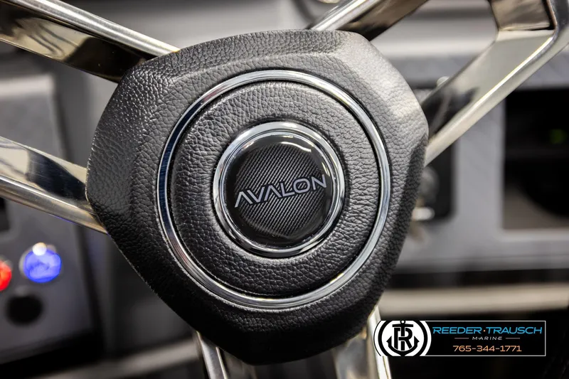 Slide: The Image of Steering wheel of 2026 Avalon CAT QLS boat with logo and control panel. - 28