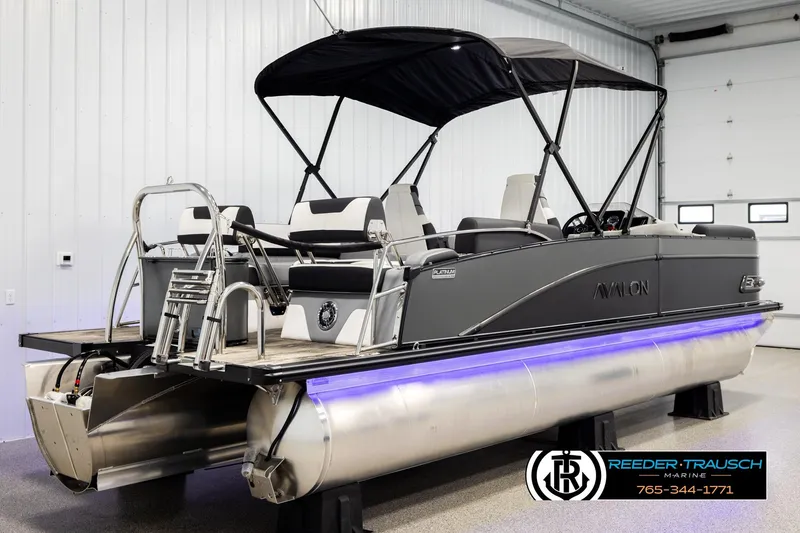 Slide: The Image of 2026 Avalon CAT QLS pontoon boat with canopy in showroom, featuring sleek design and modern amenities. - 6