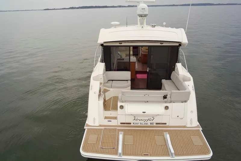 Slide: The Image of 2017 Sea Ray Sundancer 460 yacht on calm water, rear view with seating area. - 10