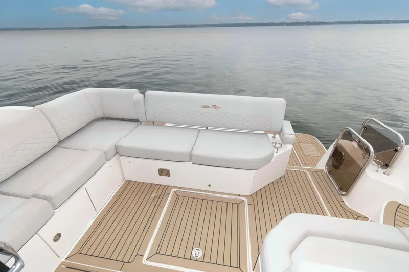 Slide: The Image of 2017 Sea Ray Sundancer 460 yacht deck with cushioned seating and scenic water view. - 14