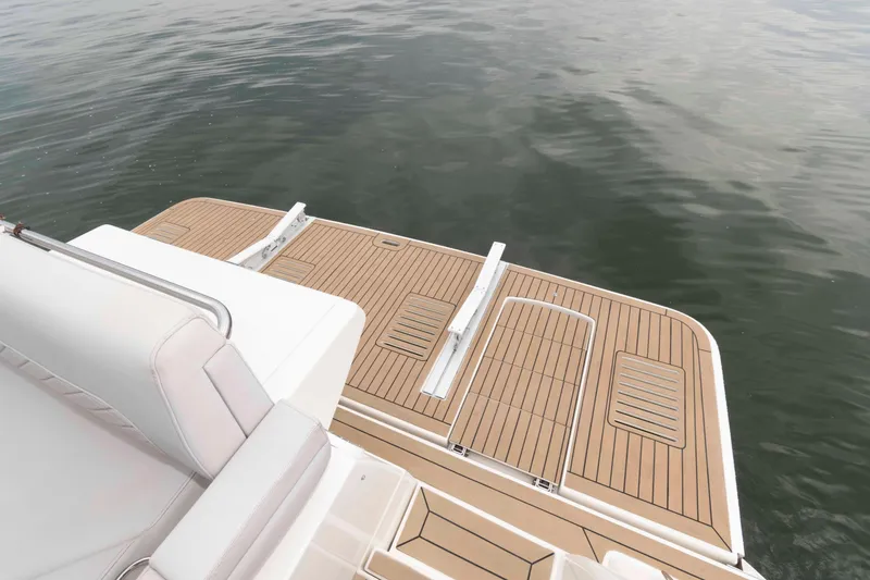 Slide: The Image of 2017 Sea Ray Sundancer 460 swim platform with teak decking on calm water. - 16
