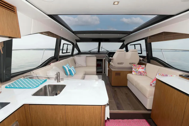 Slide: The Image of Luxurious interior of 2017 Sea Ray Sundancer 460 yacht with modern seating and kitchen area. - 20