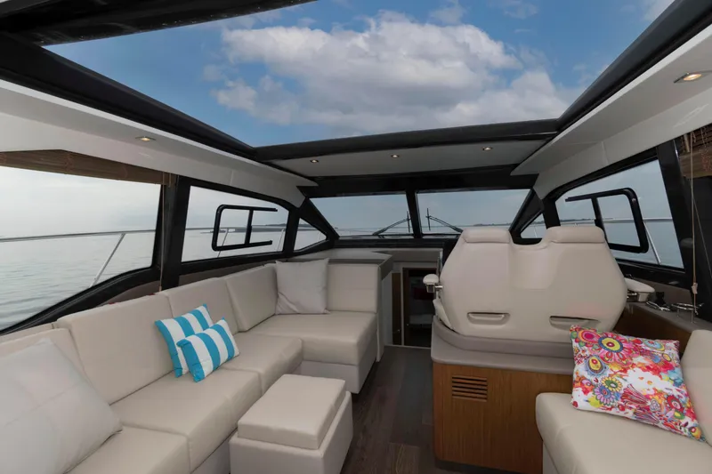 Slide: The Image of Luxurious interior of 2017 Sea Ray Sundancer 460 yacht with plush seating and panoramic windows. - 21
