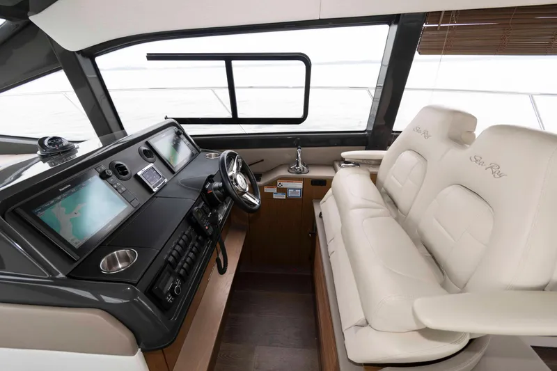 Slide: The Image of 2017 Sea Ray Sundancer 460 helm with dual screens and plush seating. - 28