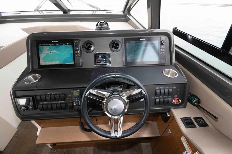 Slide: The Image of 2017 Sea Ray Sundancer 460 helm with dual navigation screens and modern controls. - 30