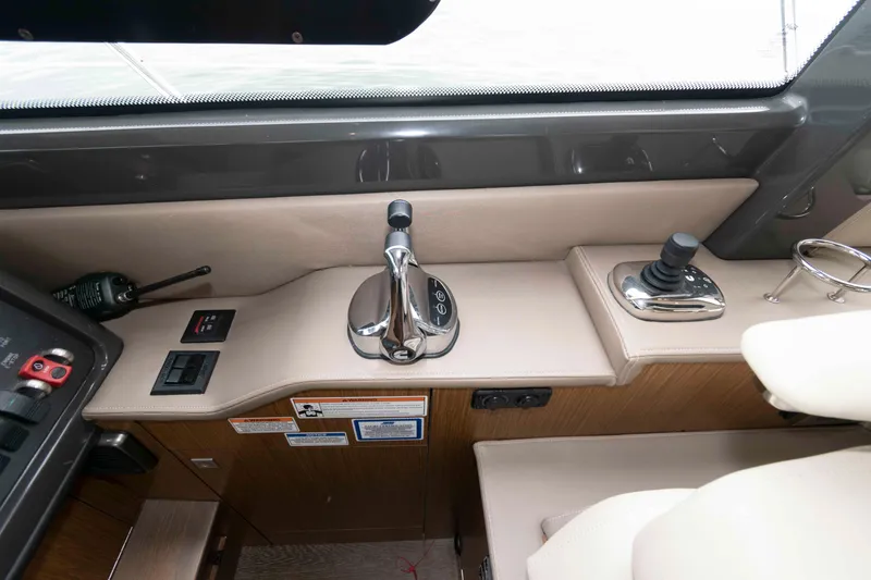 Slide: The Image of 2017 Sea Ray Sundancer 460 helm controls with joystick and throttle. - 31