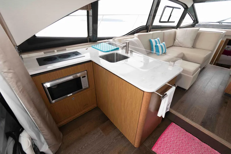 Slide: The Image of Luxurious interior of 2017 Sea Ray Sundancer 460 yacht with modern kitchen and seating area. - 32