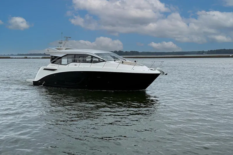 Slide: The Image of 2017 Sea Ray Sundancer 460 yacht on calm water under a partly cloudy sky. - 4