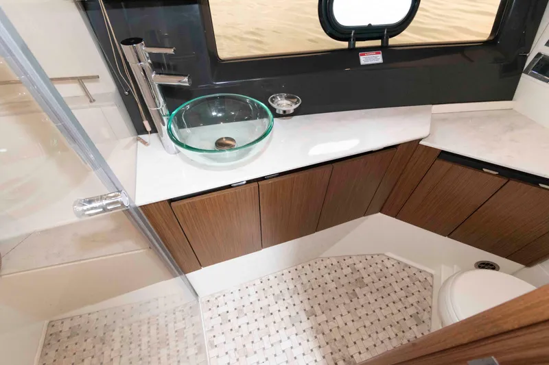 Slide: The Image of Luxurious bathroom in 2017 Sea Ray Sundancer 460 yacht with modern fixtures and glass sink. - 40