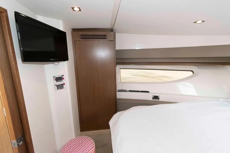 Slide: The Image of 2017 Sea Ray Sundancer 460 cabin interior with TV, window, and modern decor. - 42