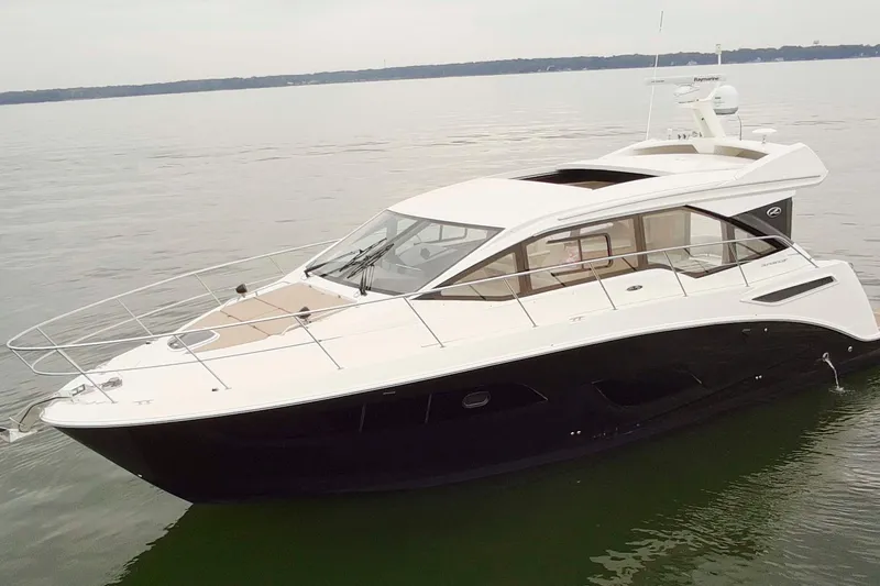 Slide: The Image of 2017 Sea Ray Sundancer 460 yacht on calm water, showcasing sleek design and luxury features. - 7
