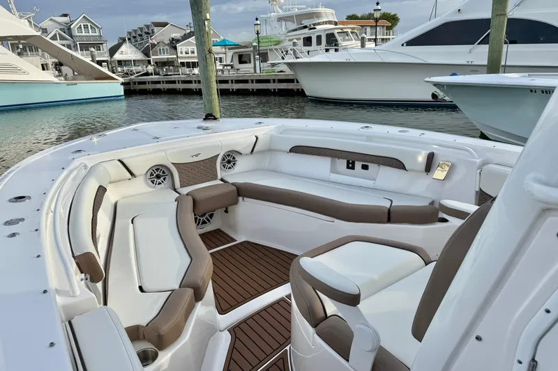 Slide: The Image of 2024 Tidewater 272 LXF boat interior with luxurious seating at marina. - 14