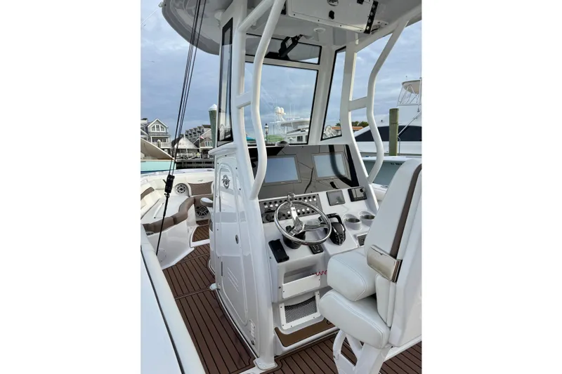 Slide: The Image of 2024 Tidewater 272 LXF boat helm with modern controls and seating. - 18