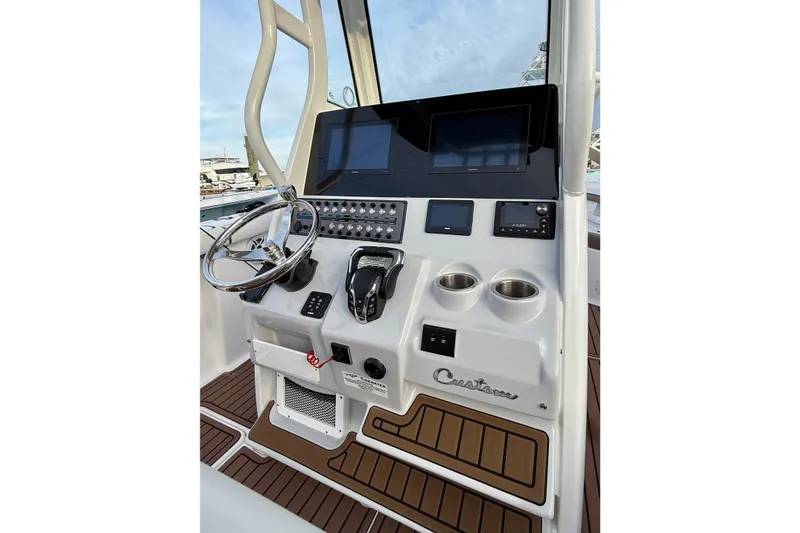 Slide: The Image of 2024 Tidewater 272 LXF boat helm with modern controls and sleek design. - 20
