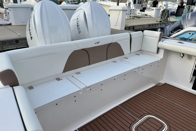 Slide: The Image of 2024 Tidewater 272 LXF boat interior with Yamaha engines and cushioned seating. - 22