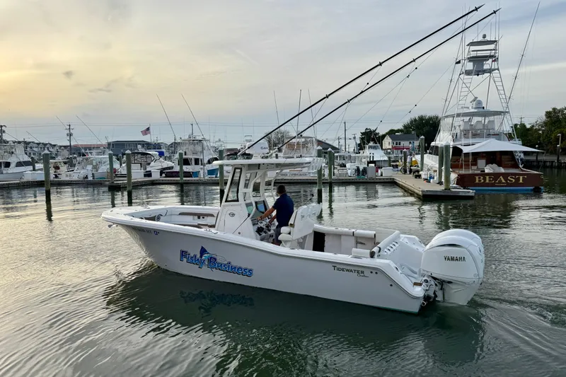 Slide: The Image of 2024 Tidewater 272 LXF boat in marina, featuring Yamaha engine, at sunset. - 26