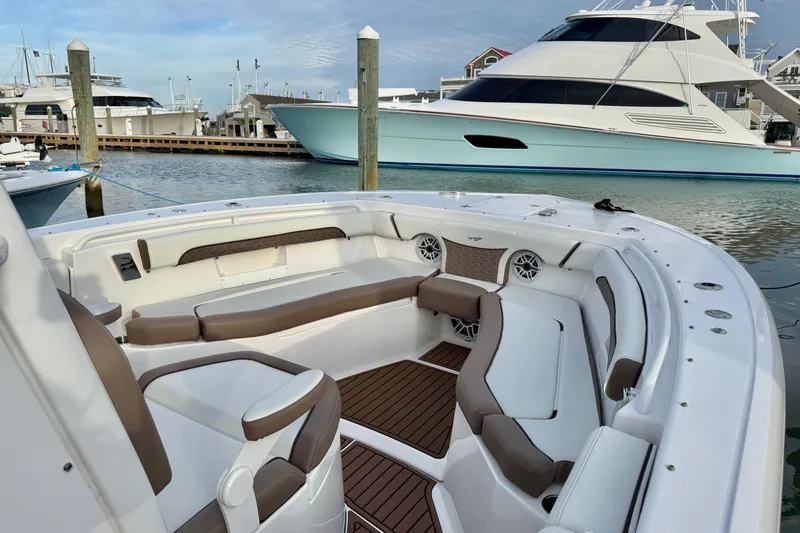 Slide: The Image of 2024 Tidewater 272 LXF boat interior with luxurious seating at marina. - 4