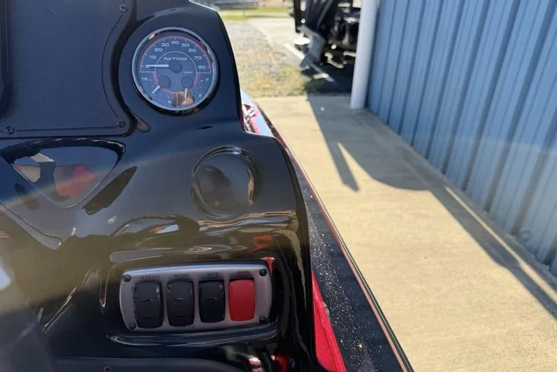 Slide: The Image of Close-up of a 2026 Nitro Z17 dashboard with speedometer and control switches. - 12