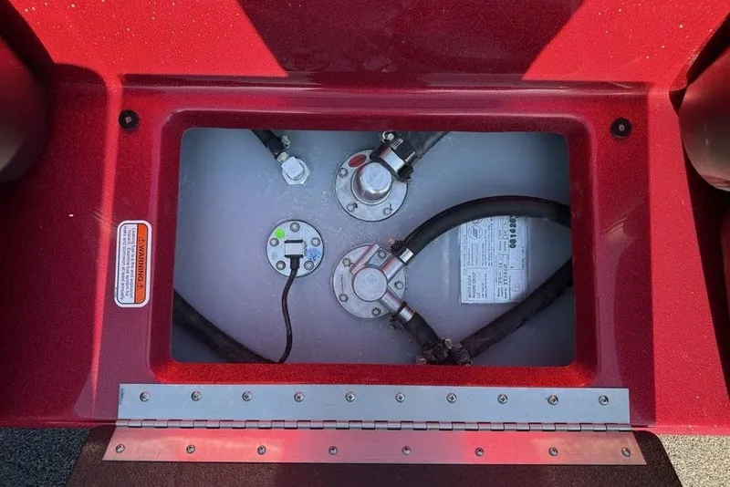 Slide: The Image of Fuel compartment of a 2026 Nitro Z17 boat, featuring hoses and warning label. - 15
