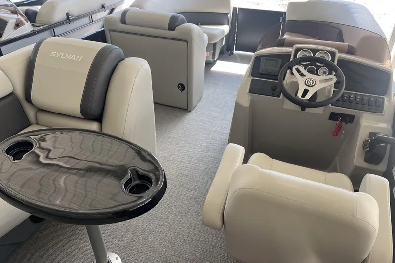 Slide: The Image of 2026 Sylvan Mirage 822 CLZ interior with steering console and seating. - 10