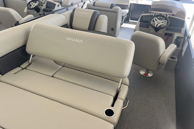Slide: The Image of 2026 Sylvan Mirage 822 CLZ boat interior with plush seating and modern dashboard. - 7