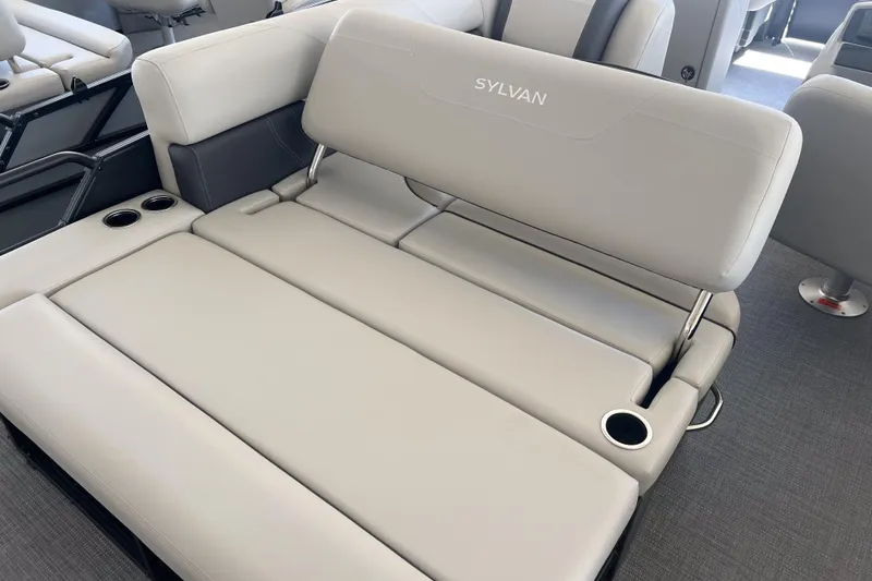 Slide: The Image of 2026 Sylvan Mirage 822 CLZ boat interior with luxurious seating and cup holders. - 9