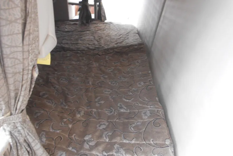 Slide: The Image of 2004 Formula 27 Performance Cruiser interior with patterned bedding and curtains. - 10