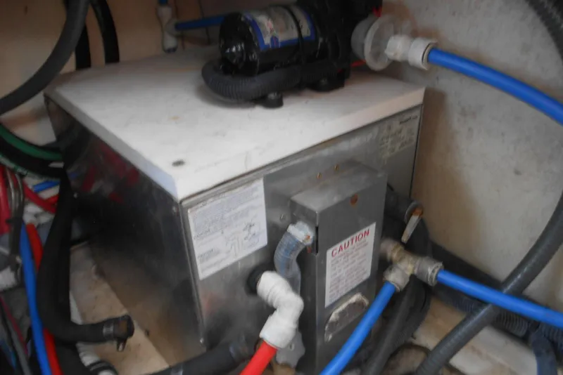 Slide: The Image of Engine compartment of a 2004 Formula 27 Performance Cruiser with visible plumbing and wiring. - 22