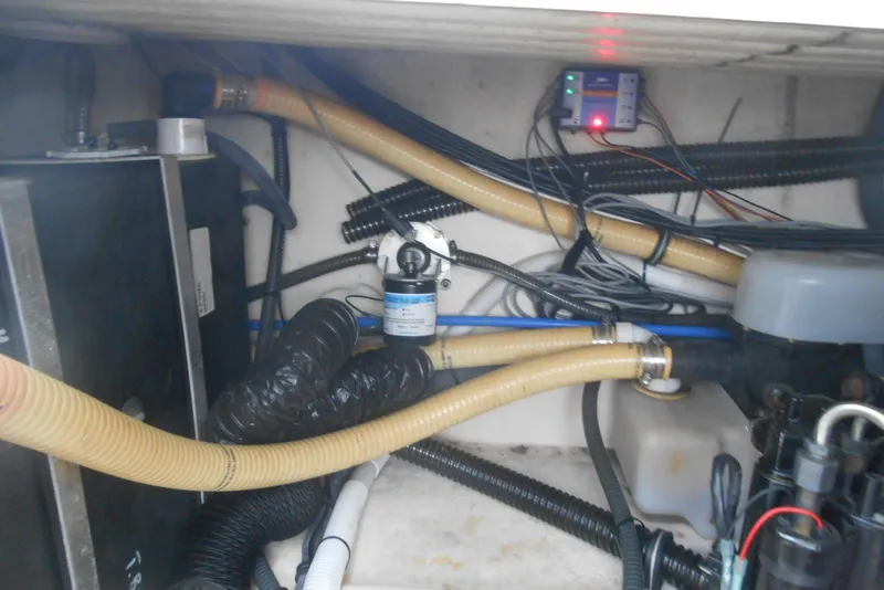 Slide: The Image of Engine compartment of a 2004 Formula 27 Performance Cruiser with visible hoses and wiring. - 23