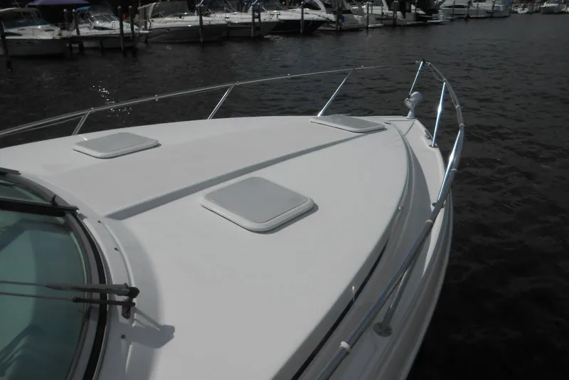 Slide: The Image of 2004 Formula 27 Performance Cruiser boat docked at marina, showing sleek deck design. - 27
