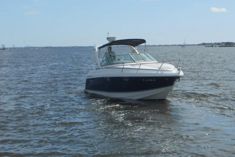 Slide: The Image of 2004 Formula 27 Performance Cruiser navigating calm waters under a clear sky. - 4