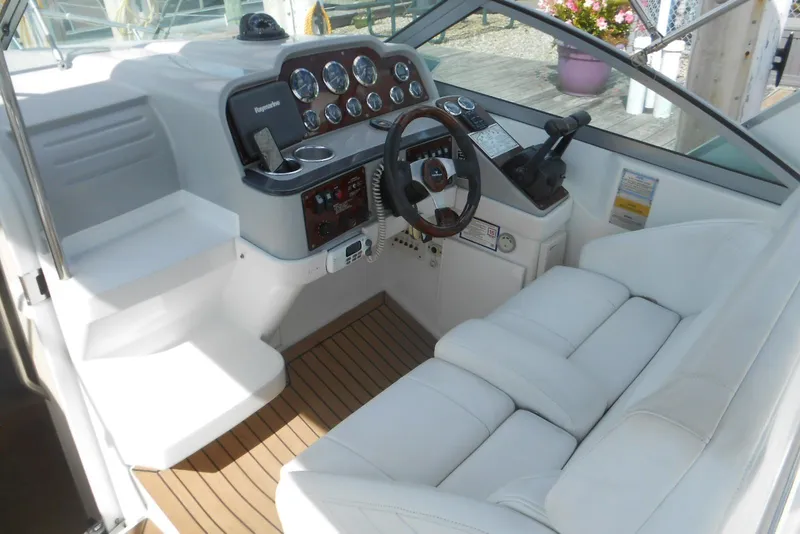Slide: The Image of 2004 Formula 27 Performance Cruiser cockpit with white seating and control panel. - 7