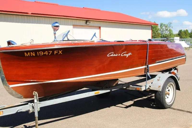 The Image of 1948 Chris-Craft 35 Double Cabin boat on trailer, wooden finish, sunny day. - 0