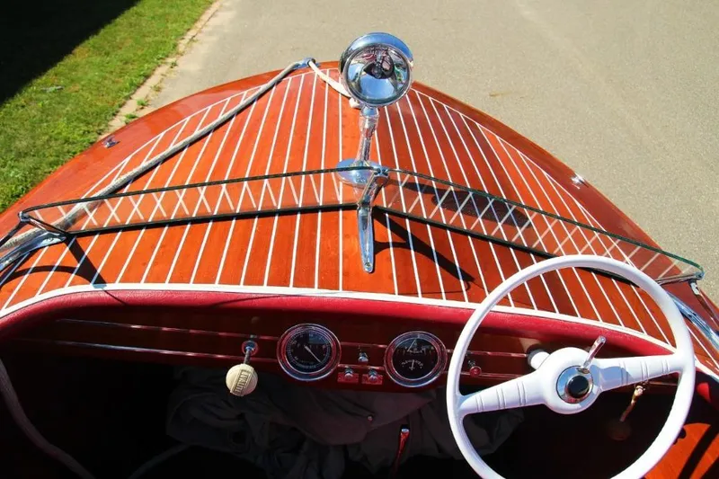 Slide: The Image of Interior of a 1948 Chris-Craft 35 Double Cabin with red leather seats and classic steering wheel. - 11