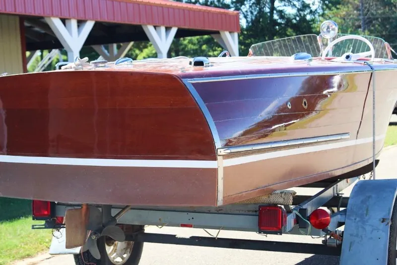 Slide: The Image of 1948 Chris-Craft 35 Double Cabin with polished wood deck and red interior, docked outdoors. - 9