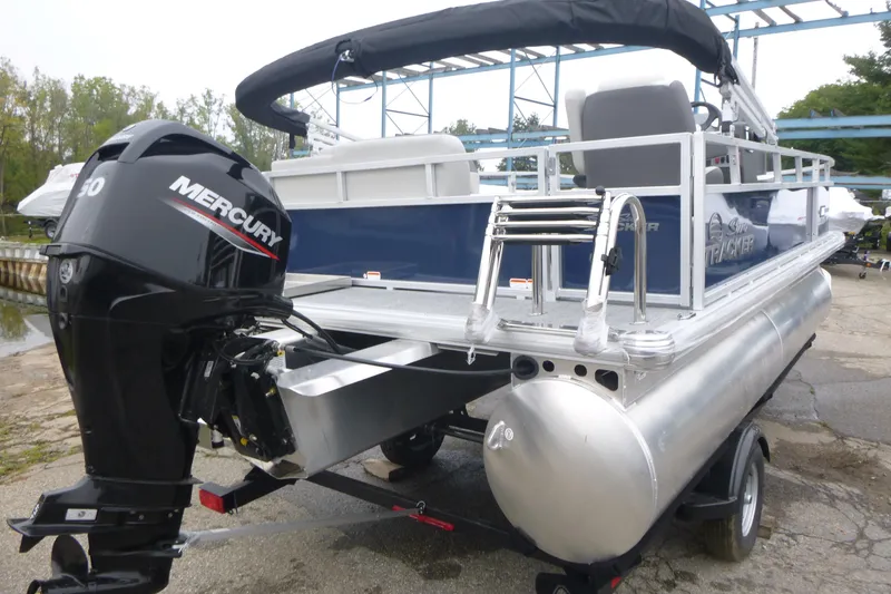 Slide: The Image of 2026 Sun Tracker Bass Buggy 16 XL Select pontoon boat, side view with logo. - 2
