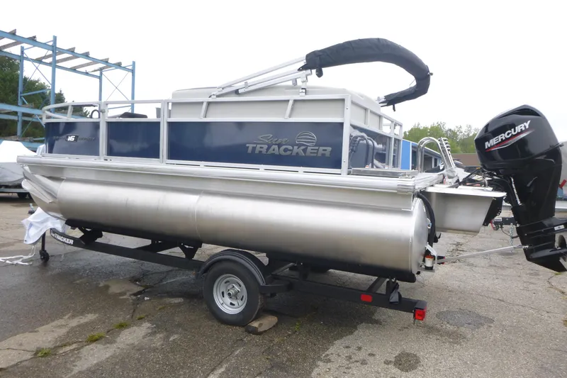 Slide: The Image of 2026 Sun Tracker Bass Buggy 16 XL Select pontoon boat, side view with logo. - 3