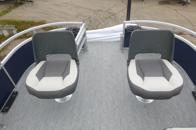 Slide: The Image of 2026 Sun Tracker Bass Buggy 16 XL Select pontoon boat interior with gray seating and steering console. - 9