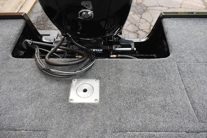 Slide: The Image of 2026 Tracker Targa V-19 WT boat interior with carpeted flooring and motor components. - 103